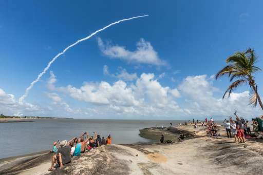 People take photos as an Ariane 5 space rocket with a payload of four Galileo satellites lifts off from ESA's European Spaceport in Kourou, French Guiana, on November 17, 2016 Image via: http://phys.org/news/2016-12-europe-satnav-galileo-due.html#jCp